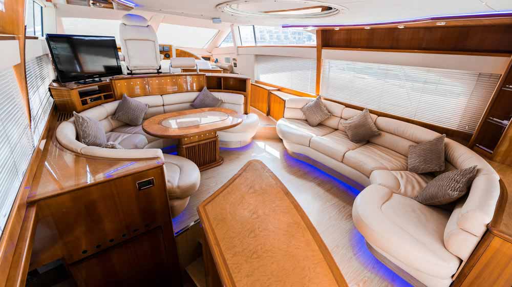 yacht lounge with furniture, leather couch, windows, led tv, control station